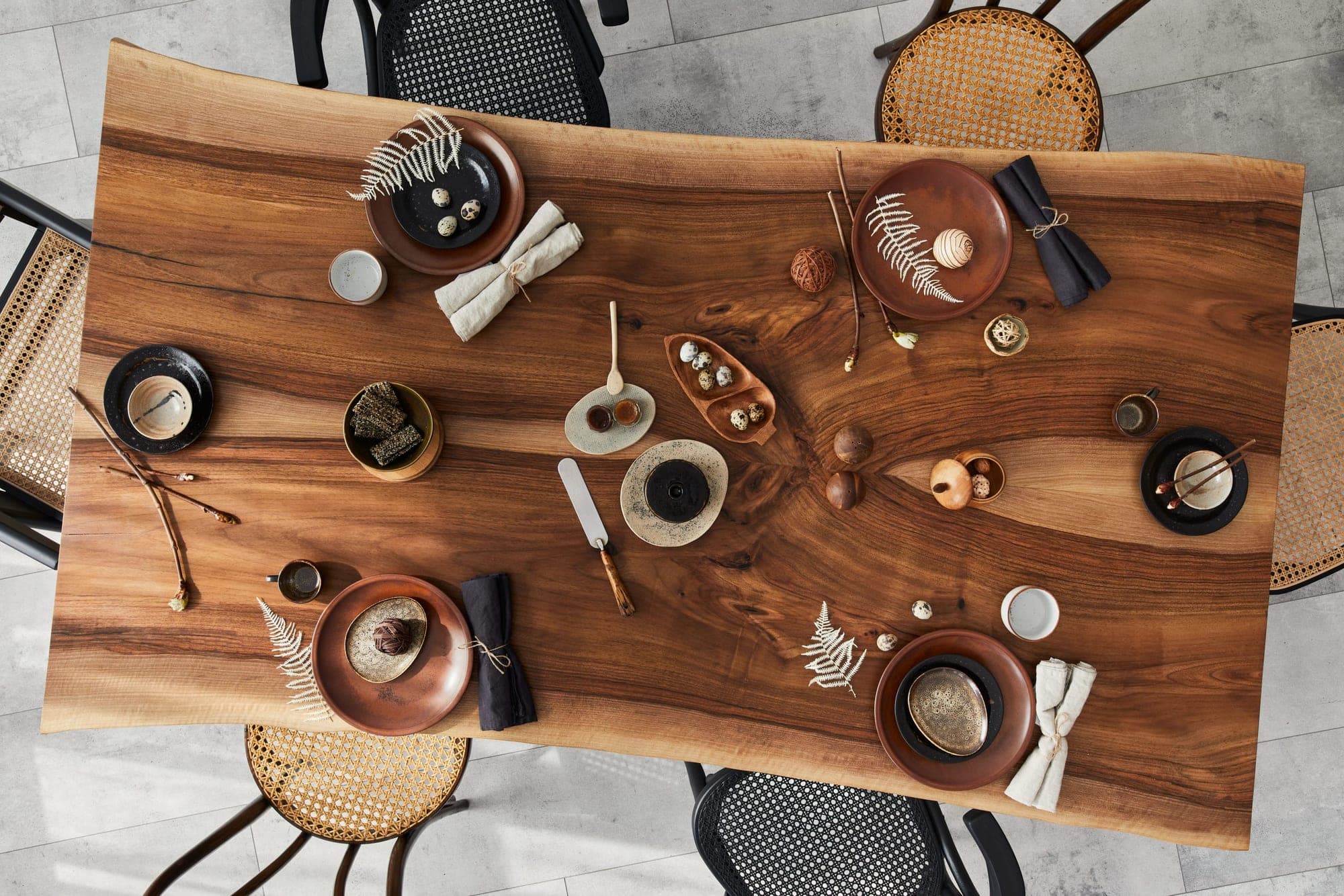 Overhead view of a live-edge wood dining table set for a meal