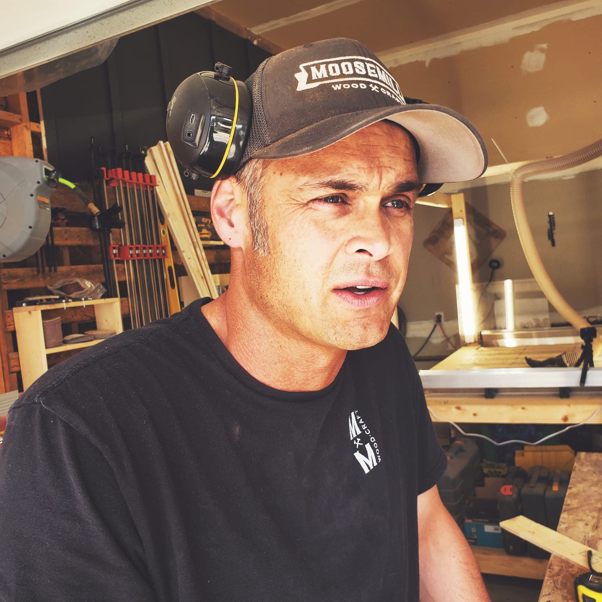 Lee Schindler in the Moose Mill workshop wearing ear protection and a Moose Mill cap