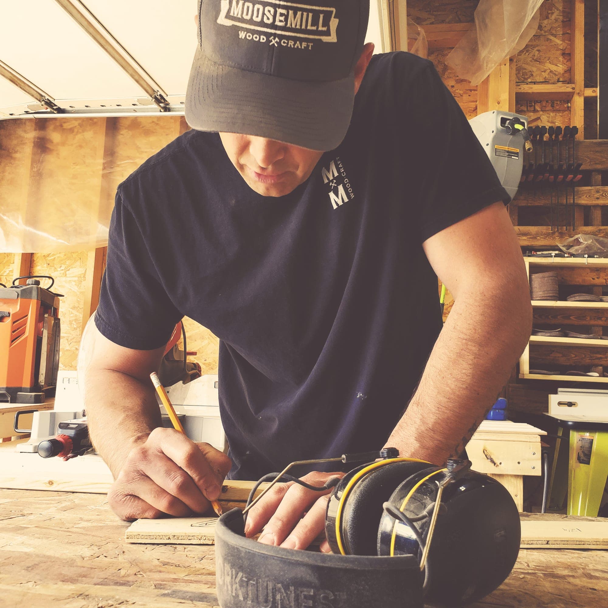 Lee marking a cut on a workpiece