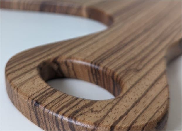 Close-up of the smooth finished edge of a zebrawood board