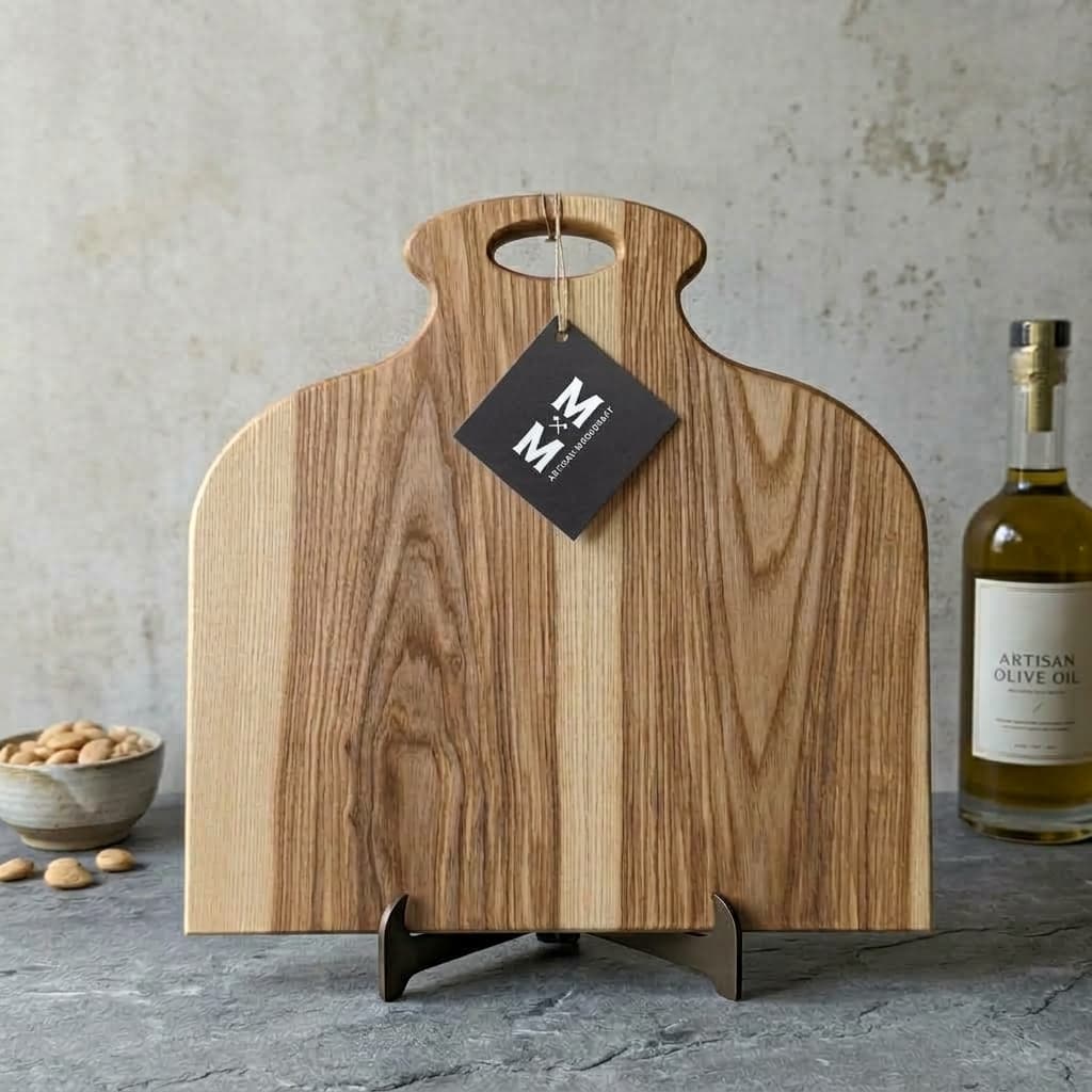 Ash Chalet charcuterie board with a cut-out handle and Moose Mill tag, standing on a display stand