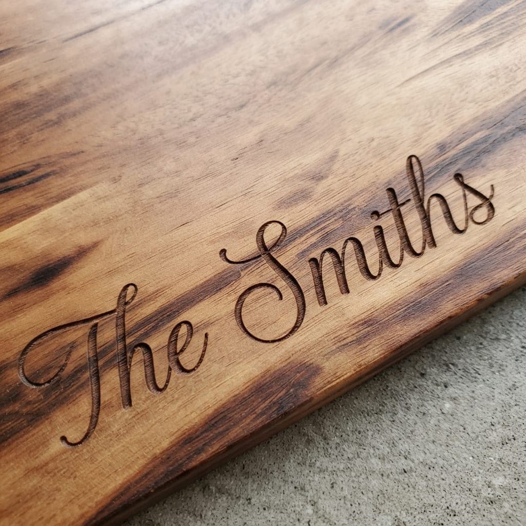 Sample name engraving reading The Smiths in script on a wooden board