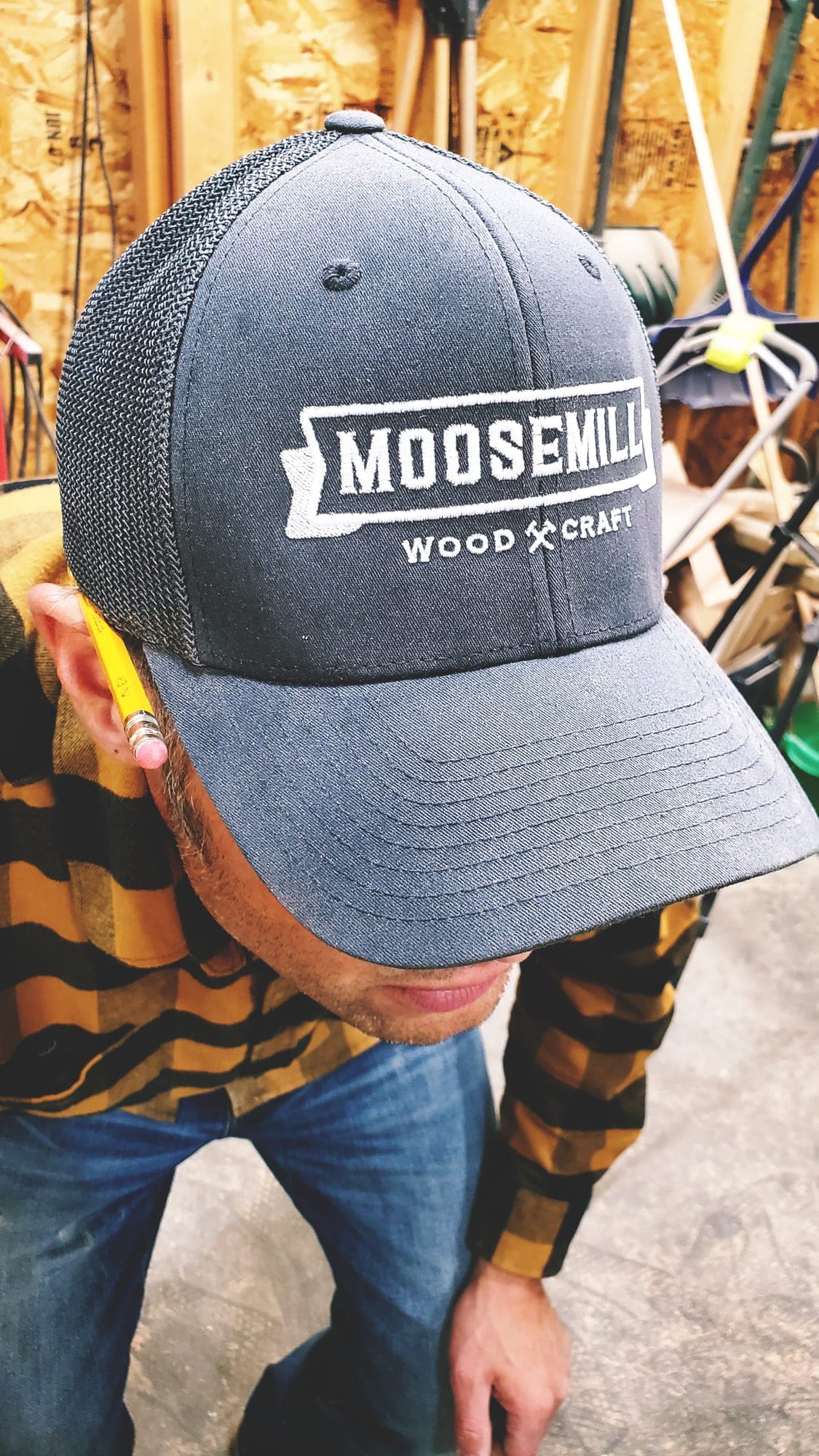 Lee wearing a Moose Mill Woodcraft cap in the shop